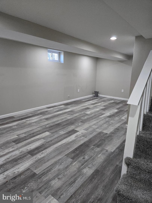 below grade area with recessed lighting, wood finished floors, and baseboards