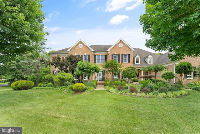 view of front of house with brick siding and a front yard