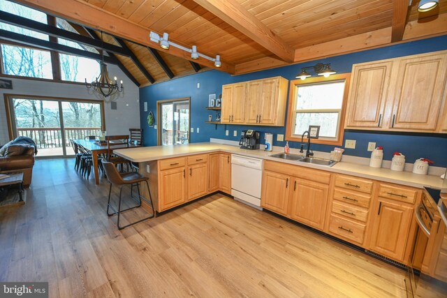 kitchen with dishwasher, a peninsula, an inviting chandelier, light countertops, and a sink