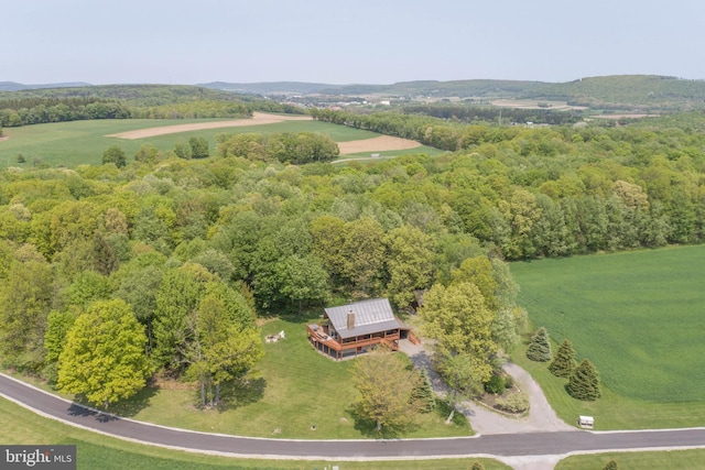 birds eye view of property with a view of trees