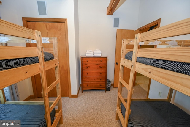 bedroom with light carpet and baseboards