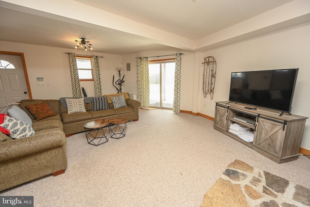 carpeted living area featuring baseboards