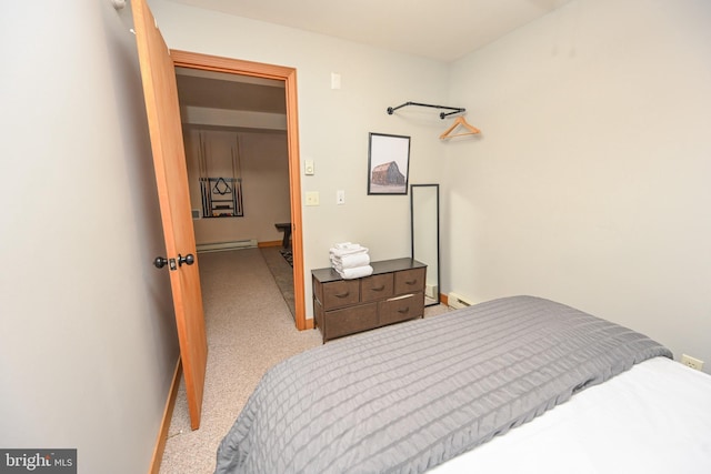 bedroom with a baseboard radiator and light colored carpet