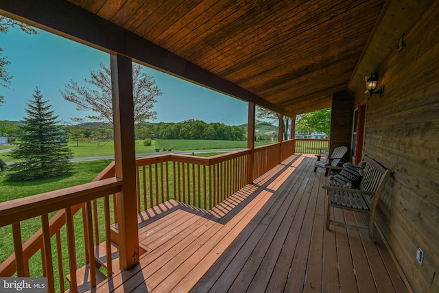 wooden deck with a lawn