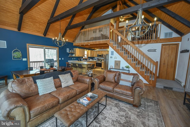 living room featuring wooden ceiling, visible vents, stairway, and an inviting chandelier