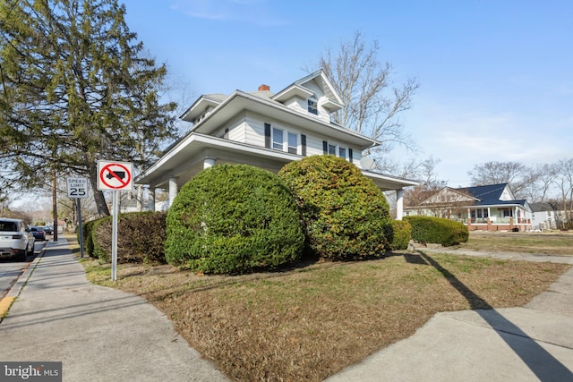 exterior space with a front lawn and a chimney