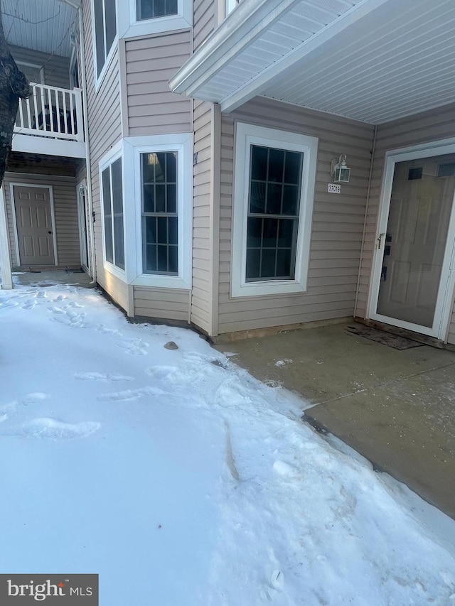 view of snow covered property entrance