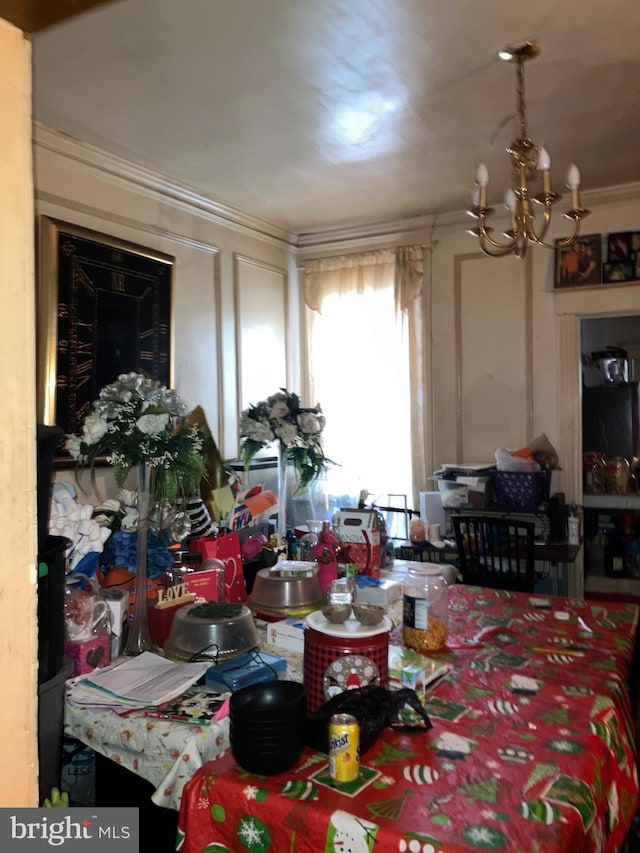 dining area with ornamental molding and a notable chandelier