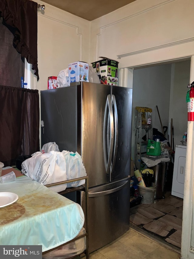 interior space featuring washer / clothes dryer and freestanding refrigerator