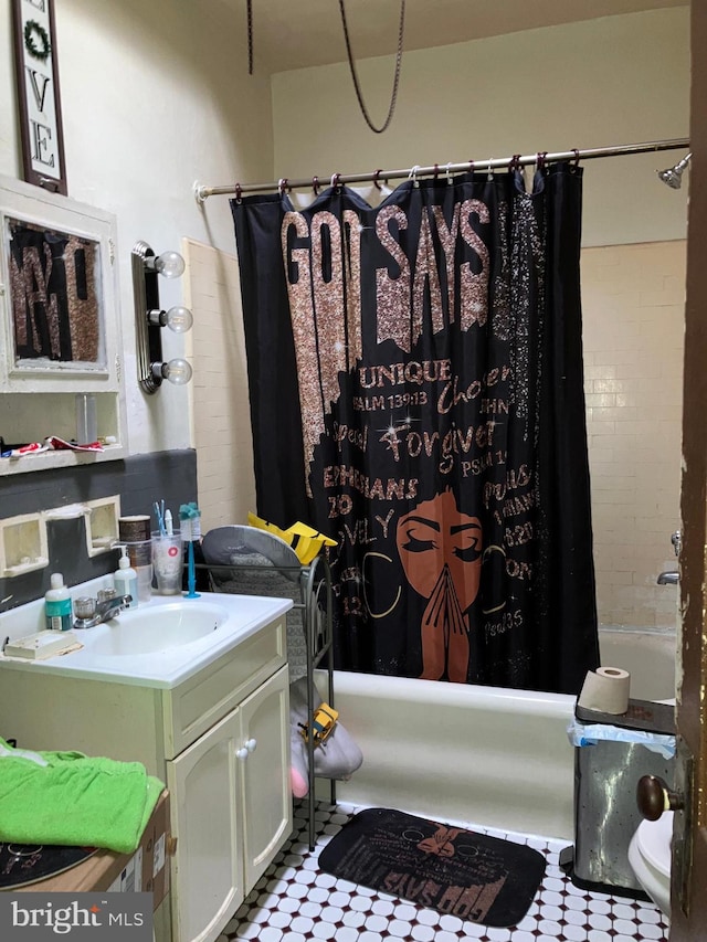 bathroom featuring shower / tub combo and vanity