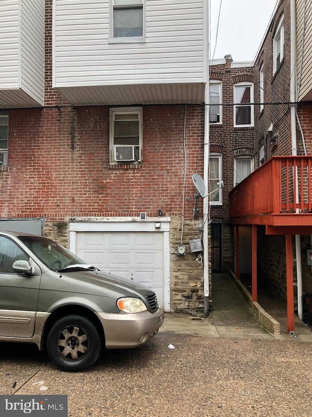 exterior space with brick siding and cooling unit