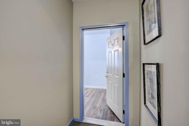 interior space featuring baseboards and wood finished floors