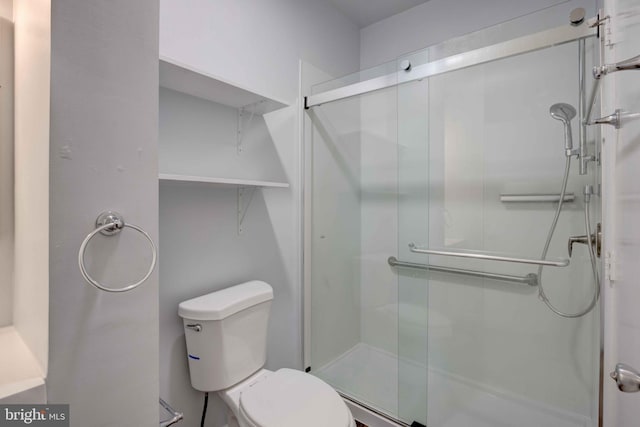 full bathroom with a shower stall and toilet