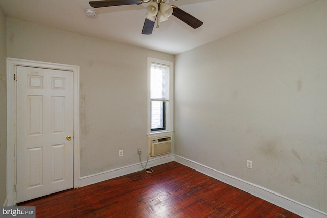 empty room featuring ceiling fan, baseboards, dark wood-style flooring, and an AC wall unit