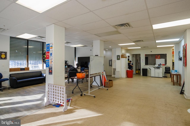 interior space featuring a drop ceiling, visible vents, and tile patterned floors