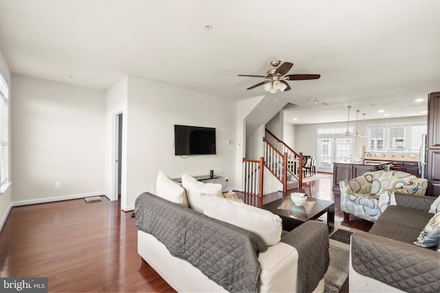 living room featuring baseboards, a ceiling fan, wood finished floors, stairs, and recessed lighting