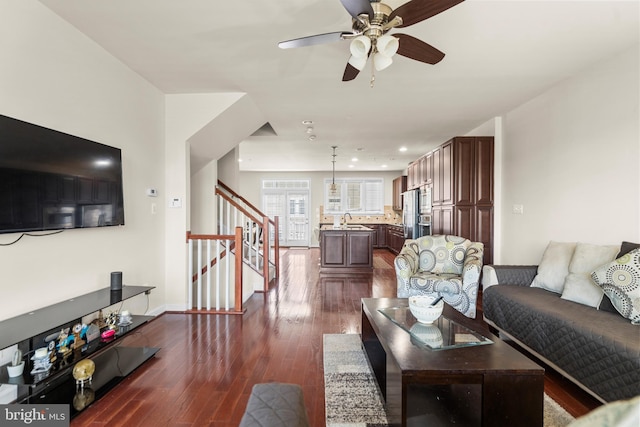 living area featuring recessed lighting, dark wood-type flooring, ceiling fan, baseboards, and stairs