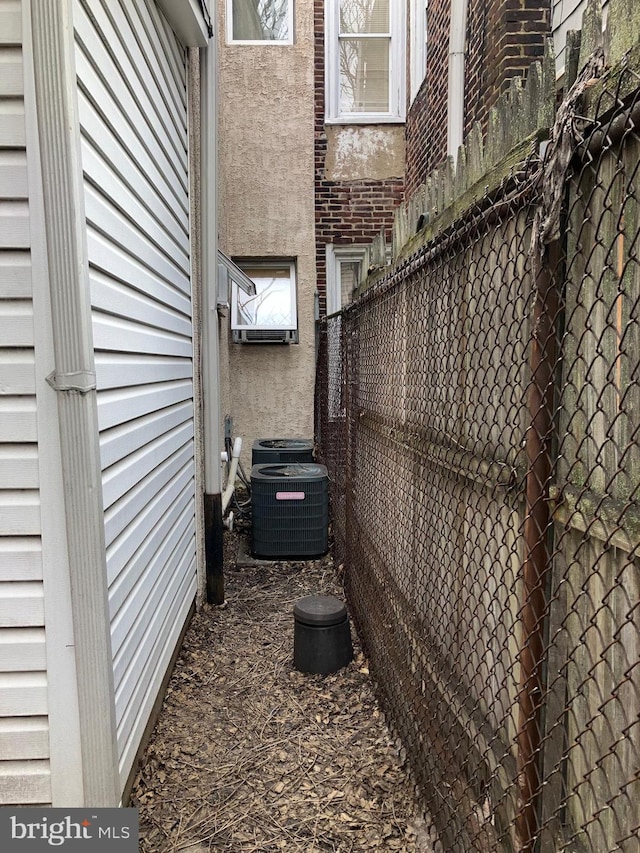 2516 S 6th St, Philadelphia, PA 19148 - view of side of property with stucco siding, fence, and central air condition unit