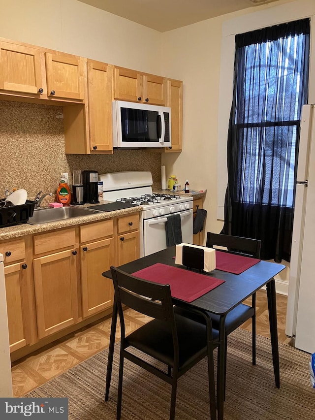 2516 S 6th St, Philadelphia, PA 19148 - kitchen with tasteful backsplash, light countertops, light brown cabinets, a sink, and white appliances