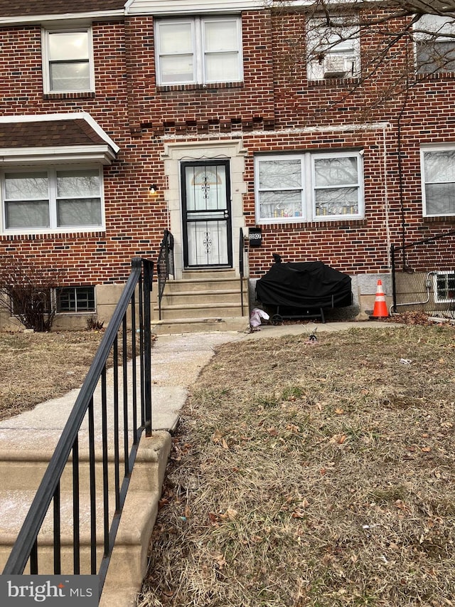 view of exterior entry with brick siding