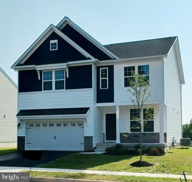 view of front facade featuring driveway, a standing seam roof, central AC, and a front yard