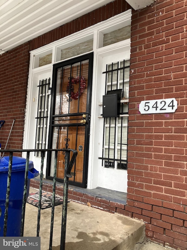 property entrance featuring brick siding