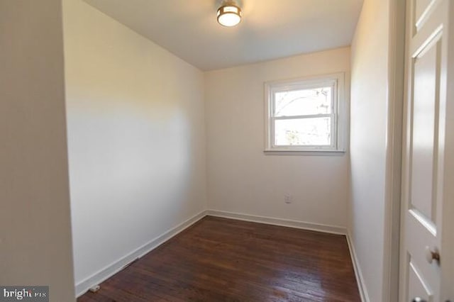 spare room with wood finished floors and baseboards