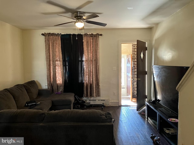 living area with hardwood / wood-style flooring, ceiling fan, and a baseboard heating unit