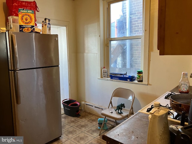 kitchen featuring freestanding refrigerator and tile patterned floors