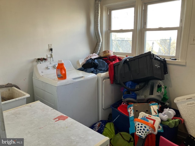 clothes washing area featuring laundry area and washing machine and clothes dryer