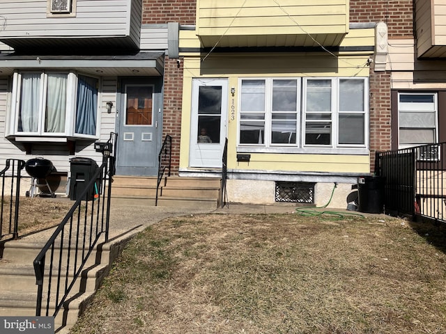 entrance to property featuring brick siding