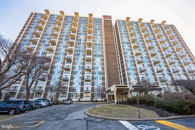 view of building exterior featuring uncovered parking