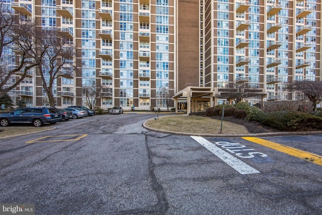 view of building exterior featuring uncovered parking