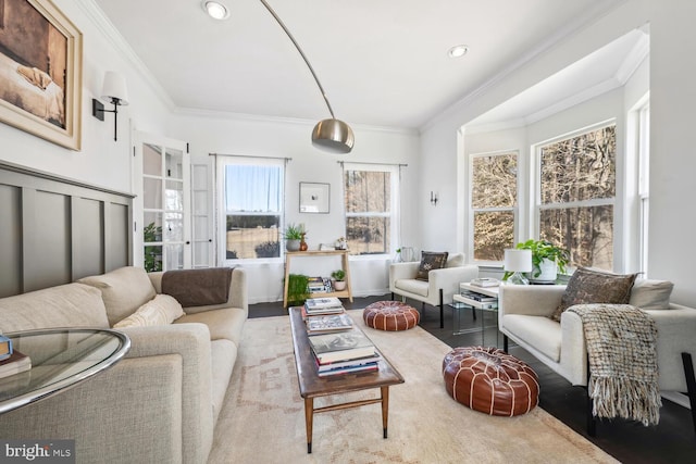 living room with ornamental molding and wood finished floors