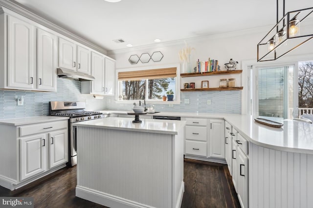 kitchen featuring under cabinet range hood, visible vents, light countertops, open shelves, and stainless steel range with gas stovetop