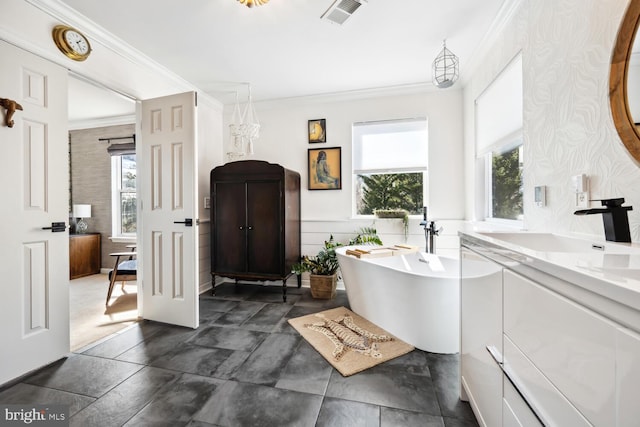 full bathroom with plenty of natural light, a freestanding bath, visible vents, and crown molding