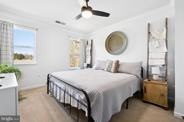 bedroom with light colored carpet, a ceiling fan, baseboards, visible vents, and ornamental molding