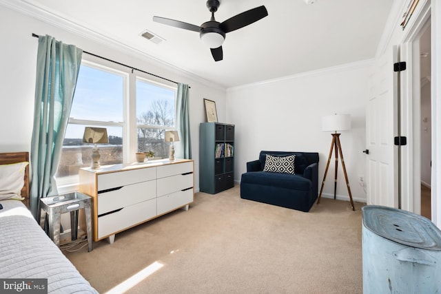 sitting room featuring a ceiling fan, light colored carpet, visible vents, and crown molding