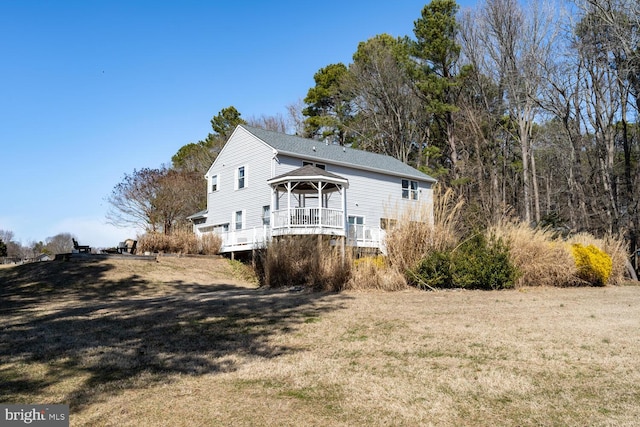 rear view of house with a gazebo and a yard