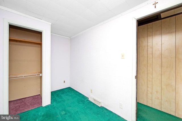 unfurnished bedroom with a closet, visible vents, and carpet flooring