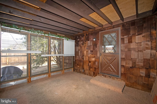 miscellaneous room with carpet and wooden walls