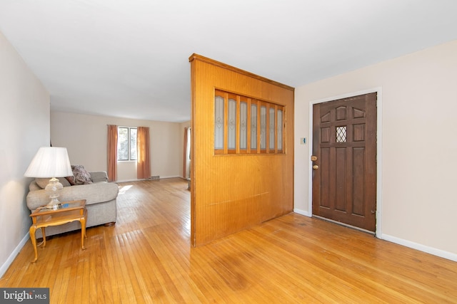 entryway with light wood-style floors and baseboards