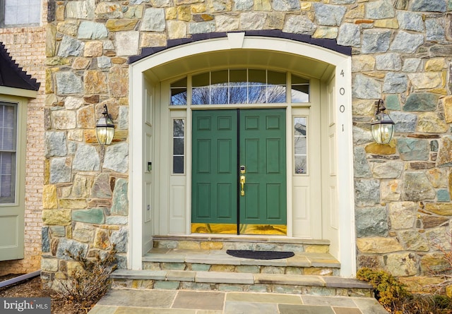 property entrance with stone siding