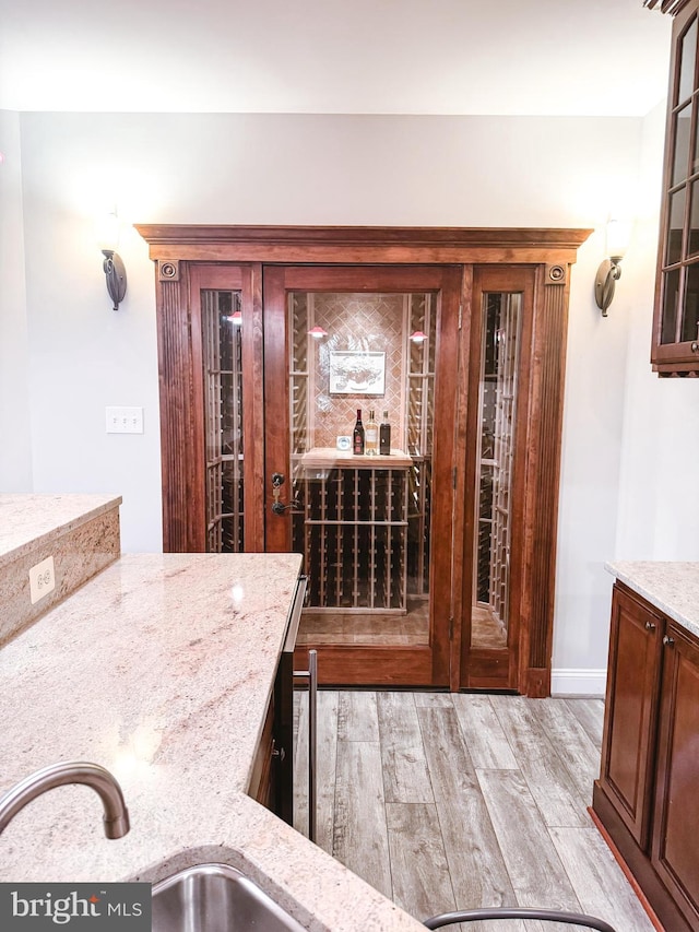 wine area with light wood-style floors and baseboards