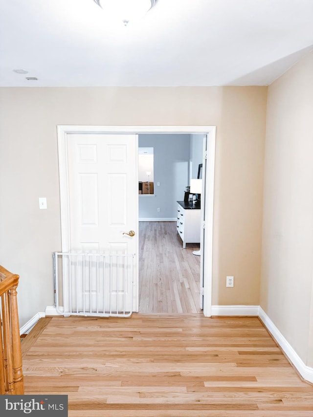 unfurnished room featuring light wood-style flooring and baseboards