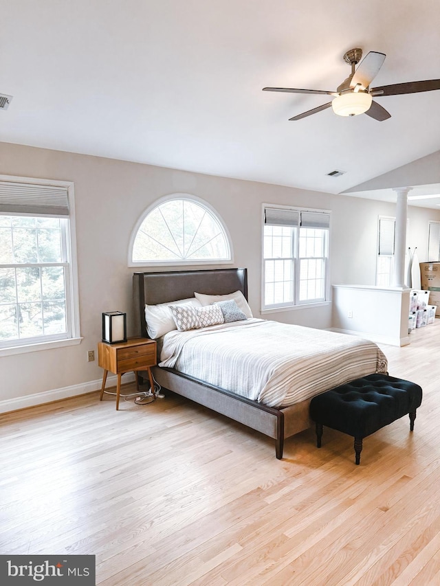 bedroom featuring multiple windows, visible vents, and wood finished floors