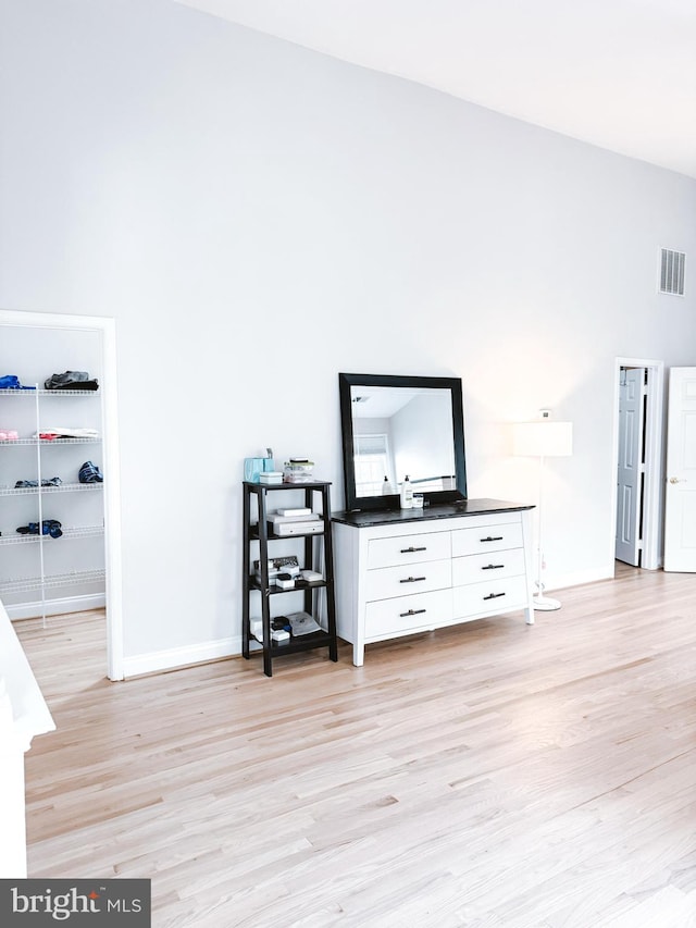 interior space with visible vents, baseboards, and wood finished floors