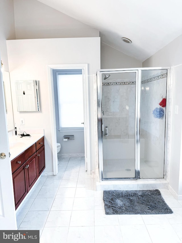 bathroom with a stall shower, lofted ceiling, toilet, tile patterned flooring, and vanity