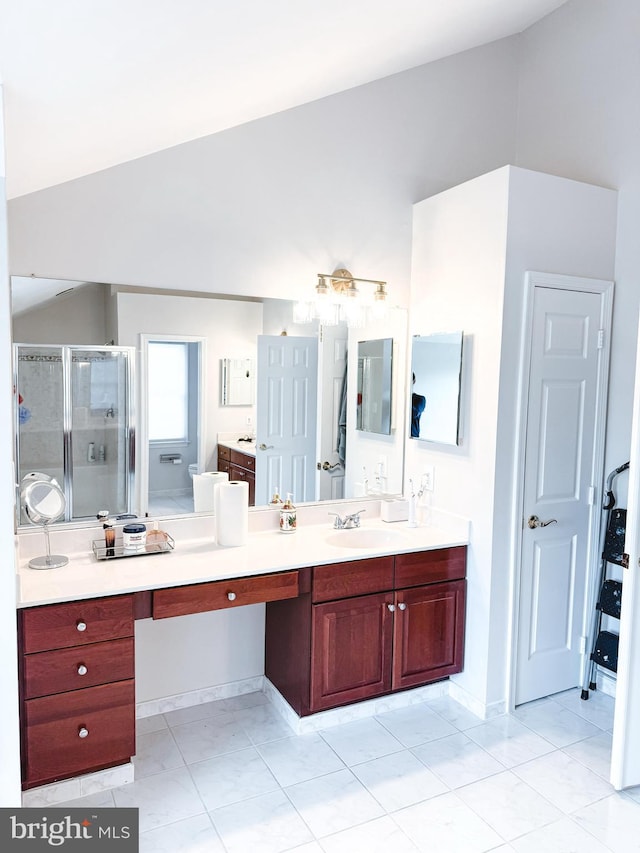 full bath featuring tile patterned floors, a shower stall, vaulted ceiling, and vanity