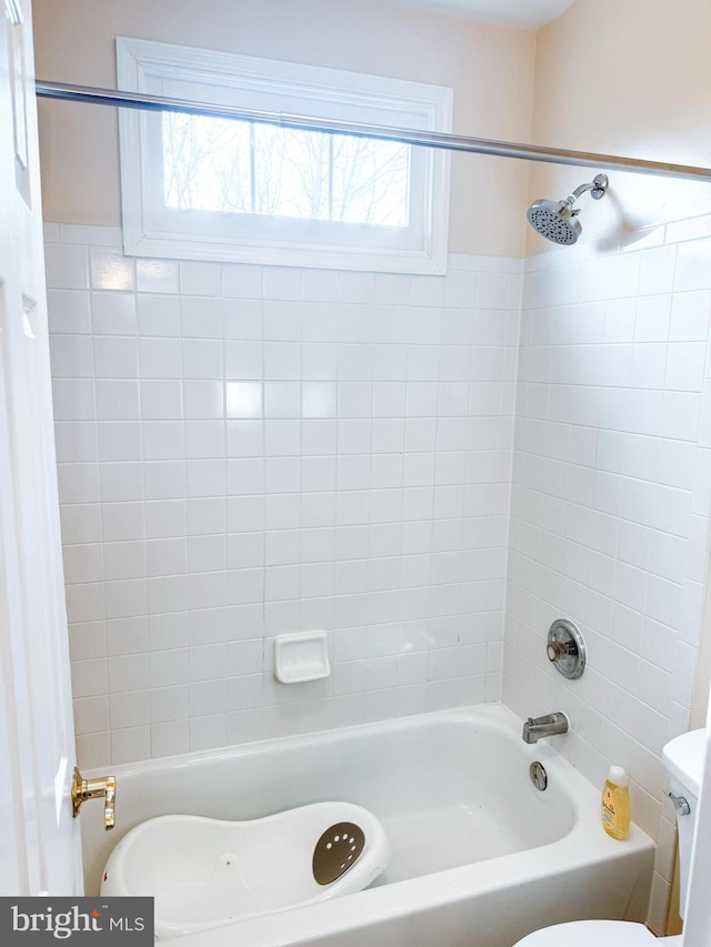 full bathroom with washtub / shower combination and toilet